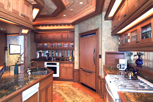 Millwork kitchen with tiered upper cabinets, coffered ceilings, inlaid floors and bronze kitchen sink