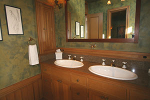 Master bath with integrated medicine cabinets and built-in chutes for dirty clothes