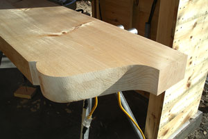 Verge beam with curved profile tail